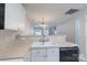 Bright kitchen featuring white cabinetry, modern faucet, and an open view into the living room at 2153 Pavilion Ct, Rock Hill, SC 29732