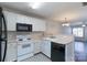 Functional kitchen with white cabinets, black appliances, and stylish flooring, open to the living area at 2153 Pavilion Ct, Rock Hill, SC 29732