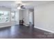 Well-lit living room with dark floors, neutral walls, and an open floor plan at 2153 Pavilion Ct, Rock Hill, SC 29732