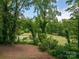 Backyard view of a golf course from a wooded lot with a tree canopy at 227 Country Club Cir, Shelby, NC 28150
