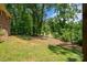 A lush backyard featuring green grass, mulch, and mature trees, offering privacy at 227 Country Club Cir, Shelby, NC 28150