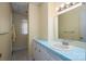 Bathroom with a wide mirror, blue countertop, white sink, and view into the next room at 227 Country Club Cir, Shelby, NC 28150
