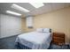 Bedroom with light blue walls, a full bed, and closet with bifold doors at 227 Country Club Cir, Shelby, NC 28150