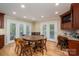 Dining area features a wooden table set surrounded by light beige walls and natural lighting at 227 Country Club Cir, Shelby, NC 28150