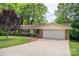 Brick ranch style home featuring a two-car garage, manicured landscaping and healthy green lawn at 227 Country Club Cir, Shelby, NC 28150