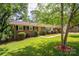 Brick ranch home with manicured landscaping and healthy green lawn at 227 Country Club Cir, Shelby, NC 28150