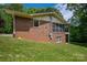 A beautiful brick home showing the side and back exterior, highlighted by a screened-in porch at 227 Country Club Cir, Shelby, NC 28150