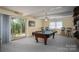 Spacious game room with a pool table, bar stools, and sliding glass doors leading to the backyard at 227 Country Club Cir, Shelby, NC 28150