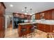 Bright kitchen with wood cabinets, granite countertops, a central island and breakfast bar seating at 227 Country Club Cir, Shelby, NC 28150