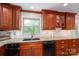 Traditional kitchen with wood cabinets, granite countertops, and a sink beneath a window at 227 Country Club Cir, Shelby, NC 28150