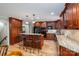 Open kitchen featuring wood cabinets, granite countertops, an island, and modern stainless steel appliances at 227 Country Club Cir, Shelby, NC 28150