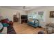 Cozy living room with wood floors, ceiling fan and multiple seating options at 227 Country Club Cir, Shelby, NC 28150