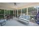 Relaxing screened-in porch featuring comfortable seating, a ceiling fan, and views of the outdoors at 227 Country Club Cir, Shelby, NC 28150