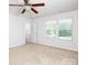 Well-lit bedroom featuring a ceiling fan, neutral carpet, and double windows at 2448 Mariners Cove Ln, Denver, NC 28037