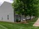 Gray home exterior showcasing well-maintained lawn, mature trees, and a welcoming facade at 2448 Mariners Cove Ln, Denver, NC 28037