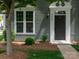 Charming gray home featuring a classic black front door with elegant white trim and manicured landscaping at 2448 Mariners Cove Ln, Denver, NC 28037
