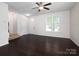 Living room with light walls, dark floors, an entrance door, and two windows at 2448 Mariners Cove Ln, Denver, NC 28037