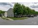 Charming gray home featuring well-manicured lawns, mature trees, and sidewalks at 2448 Mariners Cove Ln, Denver, NC 28037