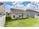 Backyard featuring a patio, lush grass, and convenient access to the home, ideal for outdoor enjoyment at 2608 Wild Azalea Ct # 9, Monroe, NC 28110