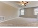 Bright bedroom with carpet flooring, ceiling fan, and natural light from multiple windows at 2608 Wild Azalea Ct # 9, Monroe, NC 28110