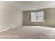 A cozy bedroom with a large window offering plenty of natural light and carpet flooring at 2608 Wild Azalea Ct # 9, Monroe, NC 28110