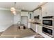 Modern kitchen with white cabinets, a large island, stainless steel appliances, and pendant lighting, perfect for cooking at 2608 Wild Azalea Ct # 9, Monroe, NC 28110