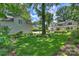 Large backyard with beautiful green grass, landscaping, and basketball court at 2627 Hampton Ave, Charlotte, NC 28207