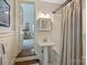 Charming bathroom featuring pedestal sink and tub with shower at 2627 Hampton Ave, Charlotte, NC 28207