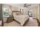 Calm bedroom featuring a ceiling fan, window, and large bed with sliding door access to an office at 2627 Hampton Ave, Charlotte, NC 28207