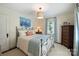 Bedroom with an iron bed, side table and dresser, and bright natural light at 2627 Hampton Ave, Charlotte, NC 28207