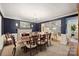 Elegant dining room with dark blue wallpaper, a decorative fireplace, and a grand chandelier at 2627 Hampton Ave, Charlotte, NC 28207