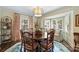 Bright dining room with a round table, bay windows, and stylish window shutters and curtains at 2627 Hampton Ave, Charlotte, NC 28207