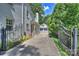 Long driveway leads to the house and detached garage through wrought iron gates at 2627 Hampton Ave, Charlotte, NC 28207