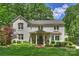 Inviting white brick home with a well-manicured lawn and beautiful, mature landscaping at 2627 Hampton Ave, Charlotte, NC 28207