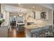 A bright kitchen featuring stainless steel appliances, custom cabinetry, and a granite countertop island at 2627 Hampton Ave, Charlotte, NC 28207