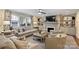 Comfortable living room featuring a fireplace, built-in shelving, and ample natural light at 2627 Hampton Ave, Charlotte, NC 28207