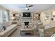 Cozy living room with fireplace, built-in shelving, plush seating, and large windows at 2627 Hampton Ave, Charlotte, NC 28207