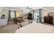 Cozy main bedroom features sitting area, ceiling fan, carpet floors, and treadmill at 2627 Hampton Ave, Charlotte, NC 28207