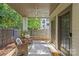 Quaint covered back porch with seating area, providing a comfortable space to relax and enjoy the outdoors at 2906 Hillside Springs Dr, Charlotte, NC 28209