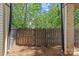 View of backyard with wooden fence surrounded by mature trees and greenery at 2906 Hillside Springs Dr, Charlotte, NC 28209