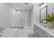 Bright bathroom featuring a glass shower, soaking tub, and dual sink vanity at 2906 Hillside Springs Dr, Charlotte, NC 28209