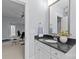 Bathroom vanity with dark countertop, white cabinets, and open view of the workout room at 2906 Hillside Springs Dr, Charlotte, NC 28209