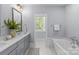 Bright bathroom featuring a dual sink vanity, soaking tub, and neutral tones at 2906 Hillside Springs Dr, Charlotte, NC 28209