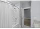 Well-lit bathroom featuring a tiled shower-tub combo next to an access door to the bedroom at 2906 Hillside Springs Dr, Charlotte, NC 28209