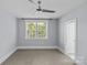 Empty bedroom with a large window and neutral carpet at 2906 Hillside Springs Dr, Charlotte, NC 28209