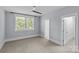 Bright bedroom with large windows, ceiling fan, and neutral carpet for a serene and comfortable space at 2906 Hillside Springs Dr, Charlotte, NC 28209