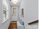 Inviting entryway with natural light, white walls, wood floors, and convenient bench seating at 2906 Hillside Springs Dr, Charlotte, NC 28209