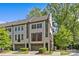 Beautiful exterior view of brick townhomes with attached garages and lush green landscaping at 2906 Hillside Springs Dr, Charlotte, NC 28209
