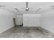 Spacious garage featuring bright lighting, clean concrete floors and white walls at 2906 Hillside Springs Dr, Charlotte, NC 28209