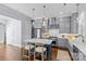 Modern kitchen with gray cabinets, stainless steel appliances, a center island with a white countertop and seating at 2906 Hillside Springs Dr, Charlotte, NC 28209